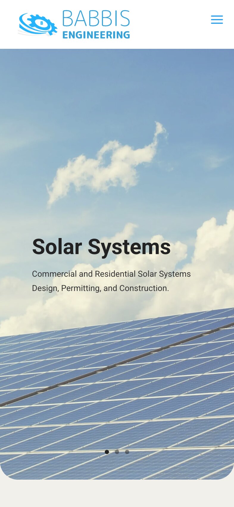 The home page on a phone: the logo and a menu button, the solar-panel photograph with the heading "Solar Systems" and the line about commercial and residential design, permitting and construction over two lines, and three slide dots near its rounded bottom edge.