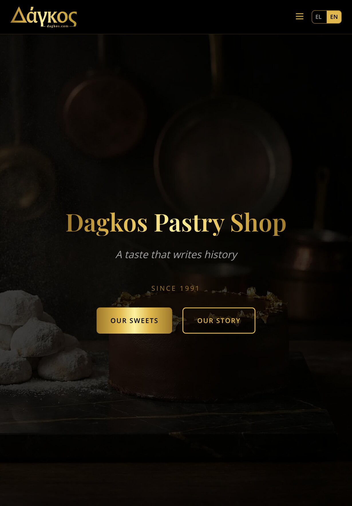 The home page on a tablet: the Δάγκος logo, a menu button and the EL | EN switch, above a dark kitchen with pans hanging in the background, a chocolate cake with gold-leaf flakes on its rim and a pile of sugar-dusted cookies on the left; over it the heading "Dagkos Pastry Shop", the tagline, "Since 1991" and the "Our Sweets" and "Our Story" buttons side by side.