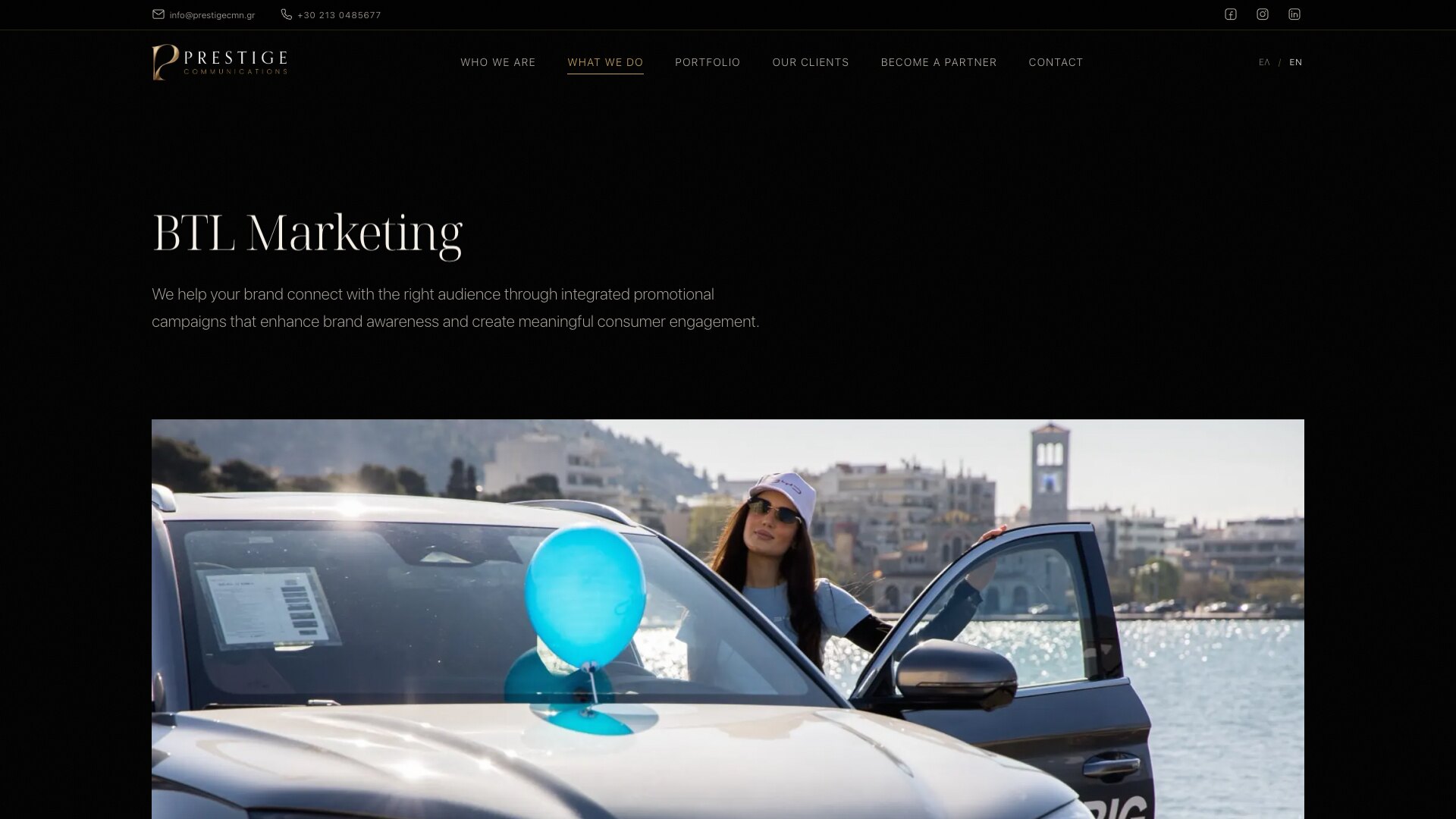 BTL Marketing 页面：标题和一句话简介下方是一张宽幅照片，一位戴白色鸭舌帽和墨镜的女士站在一辆系着蓝色气球的汽车敞开的车门旁，背景是海滨。